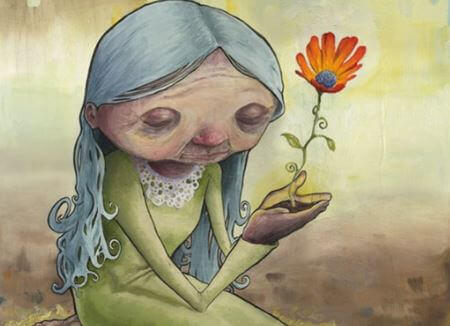 aeltere-frau-mit-blume-und-traurigem-herz
