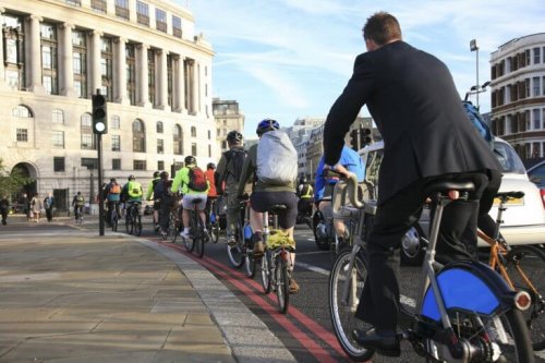 Eine Reihe an Fahrradfahrern, die den Fahrradweg benutzen.
