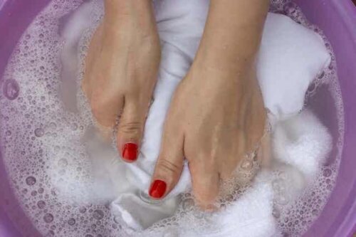 Eine Frau, die weiße Kleidung von Hand wäscht